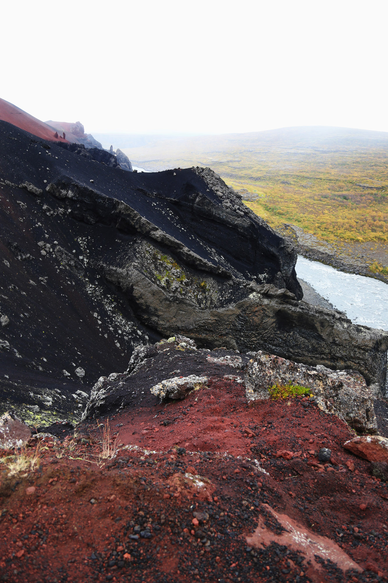 Terra vulcanica rossa e nera lungo un fiume, Islanda