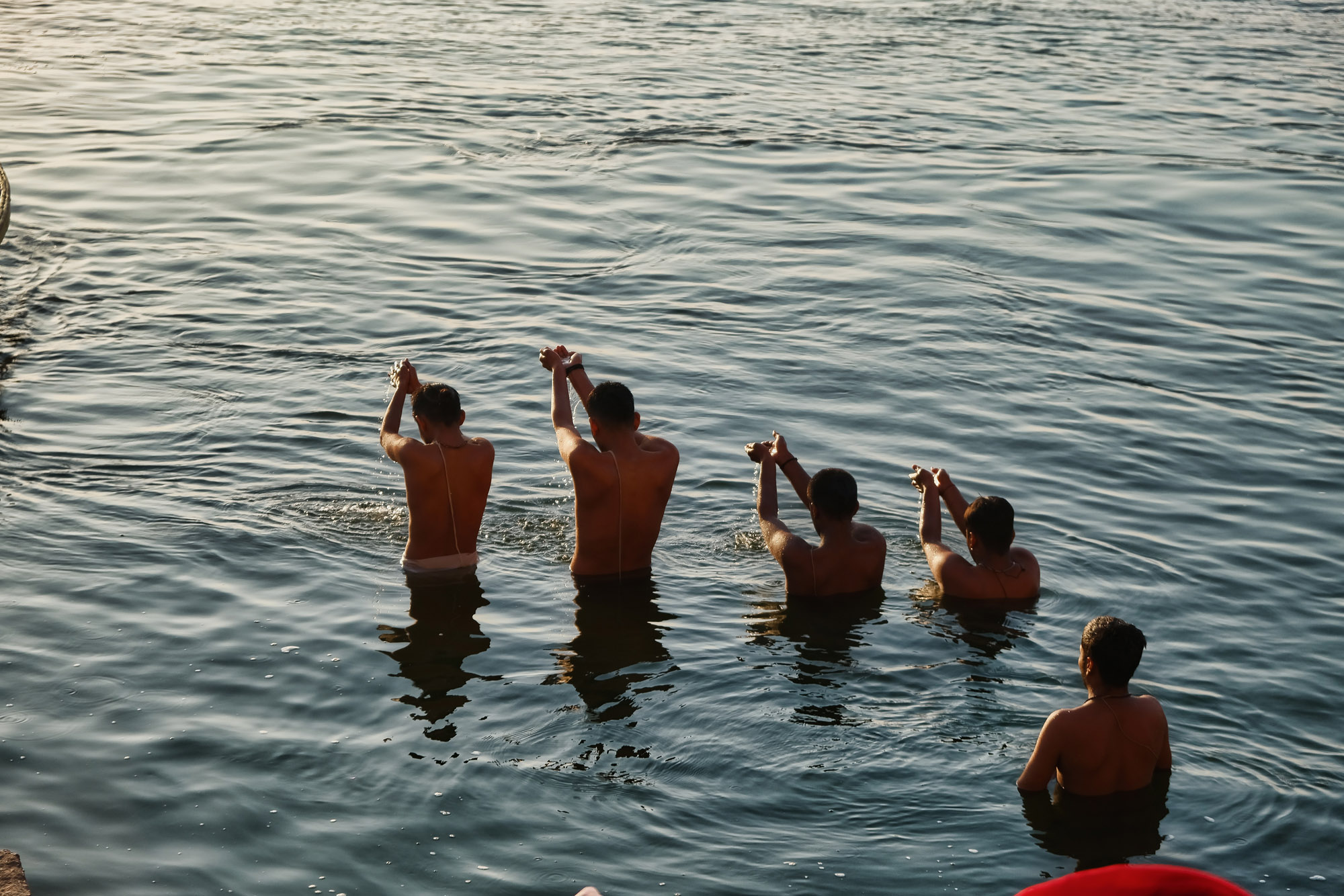 Uomini in preghiera nel Gange all'alba, Varanasi, Uttar Pradesh, India